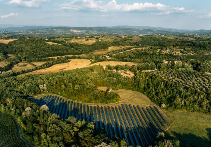 AGILITECH-project-solar-irrigation-agriculture Ariel view of ground-mounted solar system with green fields in the distance